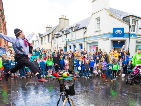 Street performer and crowd in town centre